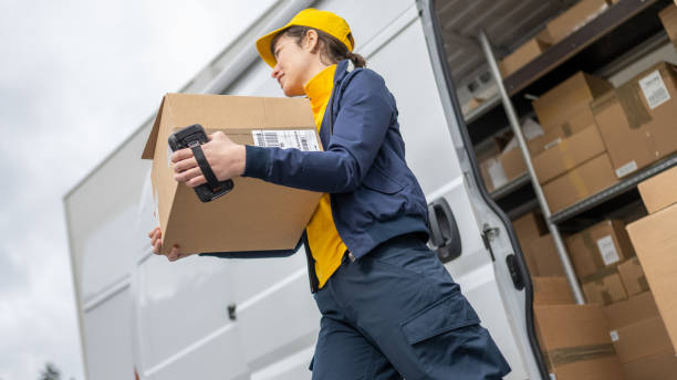 istock Delivery person carrying box 1436929117