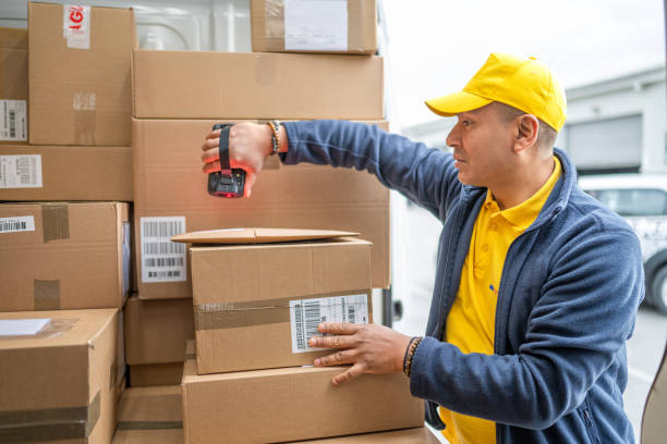 istock Delivery man scanning packages 1436929126