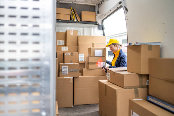 istock Delivery woman scanning packages 1436929131