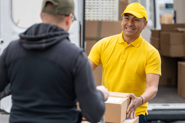 man delivering package to customer - polo shirt two people men working imagens e fotografias de stock