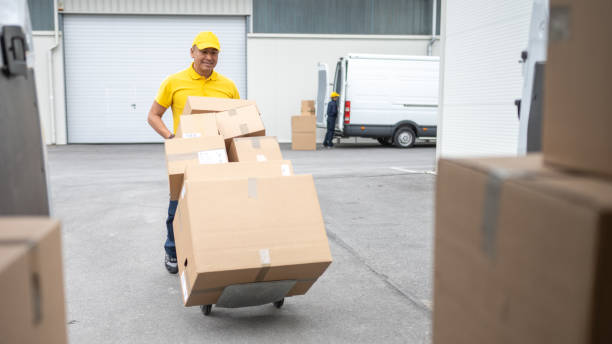 istock Delivery person moving cardboard boxes 1436929138