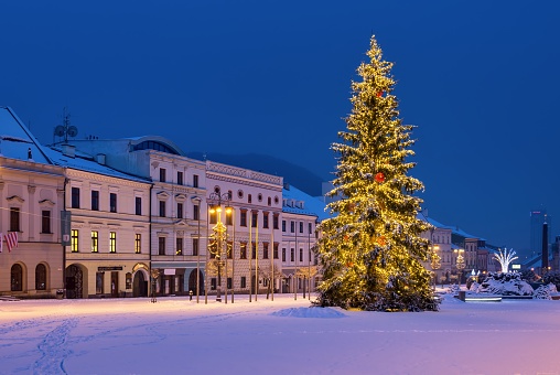 BANSKA BYSTRICA, SLOVAKIA - JANUARY 20, 2021: Snowy Christmas square in Banska Bystrica with Christmas tree. Beautiful holidays in heart of Slovakia. Winter monuments.