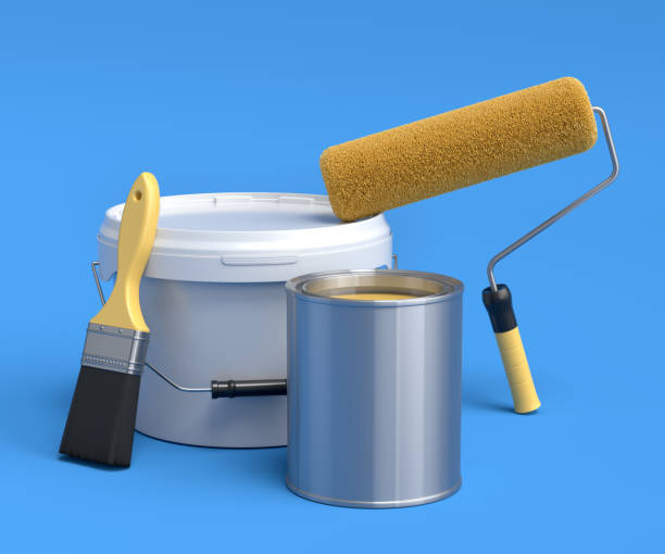 Set of metal and plastic buckets, paint roller and brush on blue background. stock photo