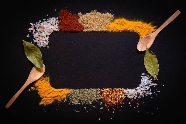 istock Various spices spoons on black background with copy space top view 1436935782