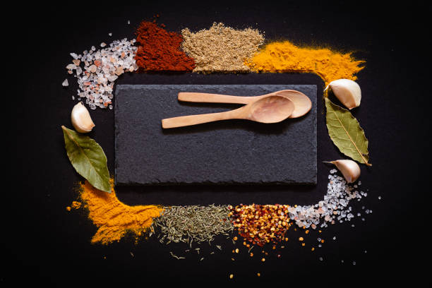 istock Various spices spoons on black background with copy space top view 1436935847