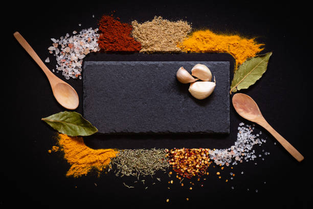 istock Various spices spoons on black background with copy space top view 1436935849
