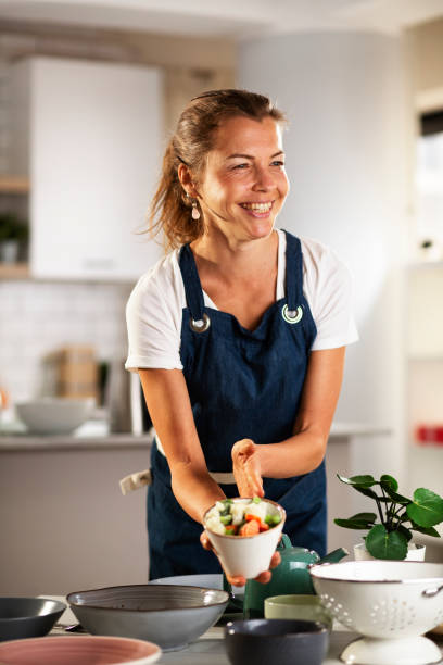 istock Young woman setting a table for lunch 1436938894