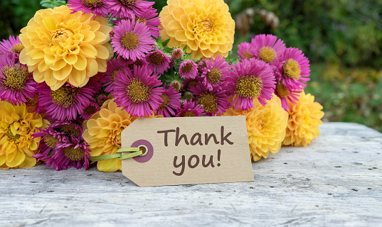 Greeting card with a bouquet of autumn flowers and the text in English: Thank You