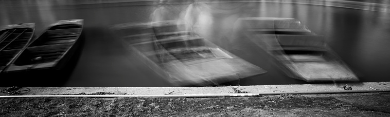 Long exposure of Cambridge punts on the River Cam.