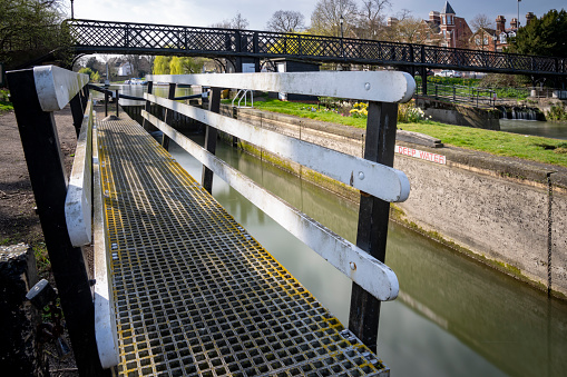 Picturesque canal lock in the UK on sunny summer day. Taunton and Bridgewater Canal, Maunsel Lock, UK, wide angle, copyspace at top.