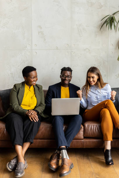 istock Multiracial group of coworkers preparing for a meeting using a laptop 1436945451
