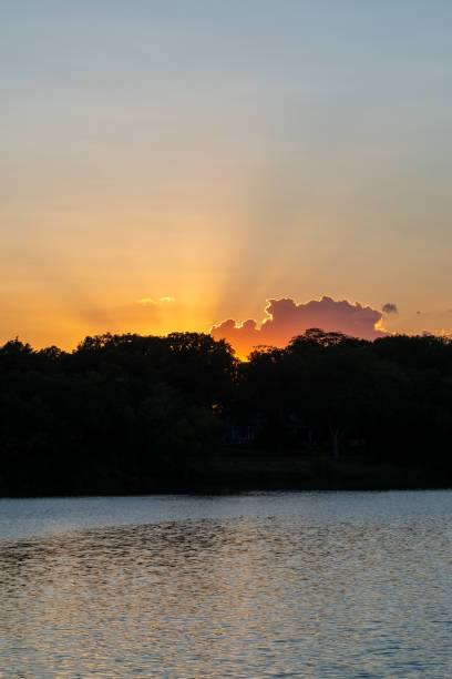 istock Clouds reflections and beautiful colors of a tranquil sunset at Lake Alice. 1436946855