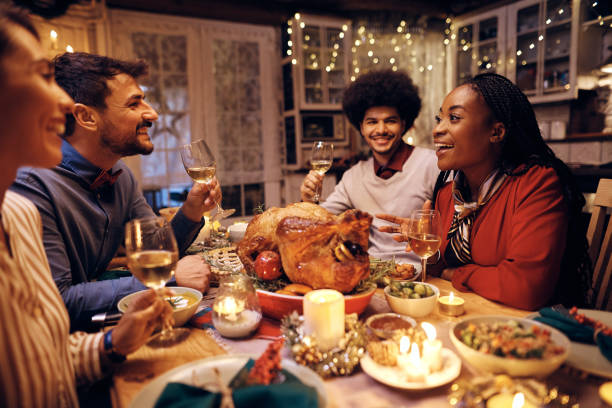 istock Two happy couples talking during Thanksgiving meal in dining room. 1436949567