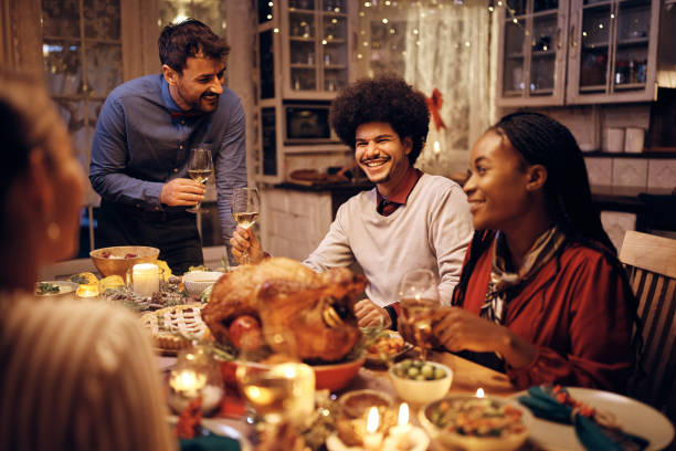 istock Happy Middle Eastern man and his friends talking while gathering for dinner on Thanksgiving. 1436949593