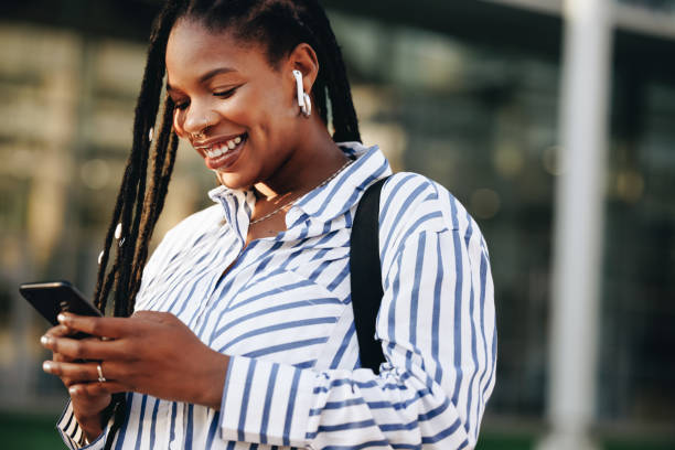 istock Cheerful young business woman using a smartphone while commuting in the city 1436949769