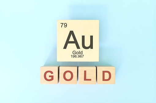 Gold chemical element symbol with atomic mass and atomic number in wooden blocks flat lay composition. Chemistry and Science concept.