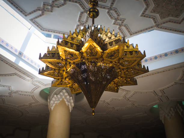 Hassan II Mosque, Casablanca, Morocco - July 10 2019 : A uniquely shaped brass lantern light hangs within the Mosque complex.