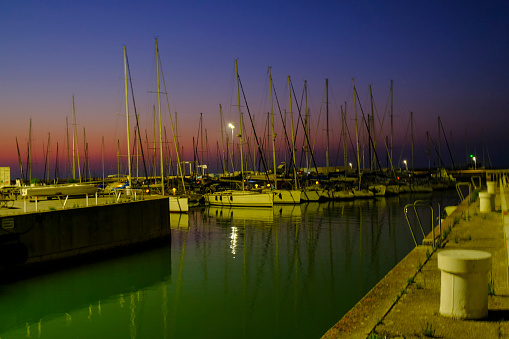 view of the harbor of Senigallia, Italy on the sunset over the yachts and boats. Urban view. City postcard