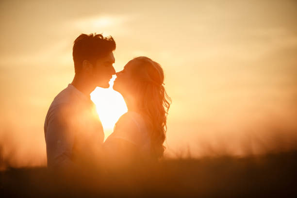 istock Passionate couple kissing under the sunset light 1436952379