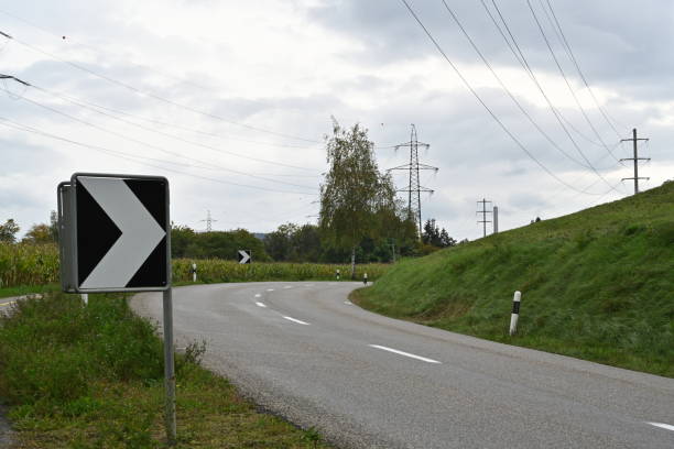 istock Warning black and white arrow traffic sign on sharp, dangerous road bend in a mountainous area. 1436952812