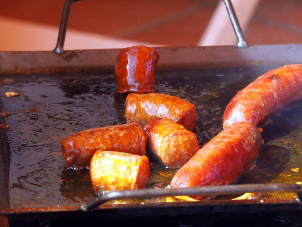 istock Grilling sausages on a barbecue grill 1436952893