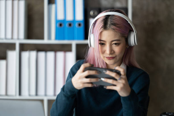istock Young female student study in the school library.She using laptop and learning online. 1436955205