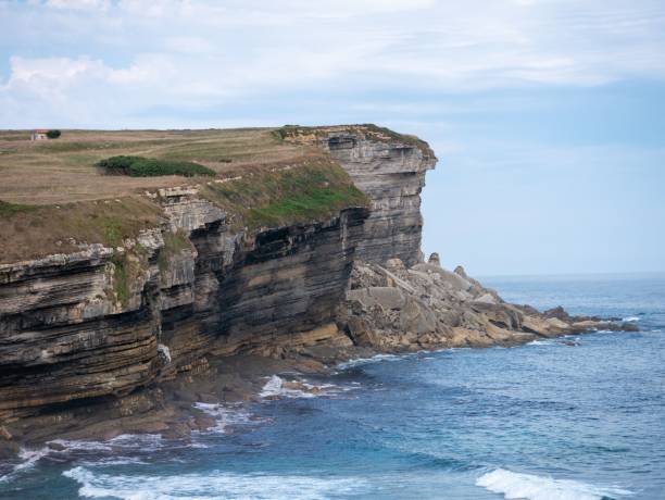 istock Rocky coastline with splashing waves on a sunny day 1436955261