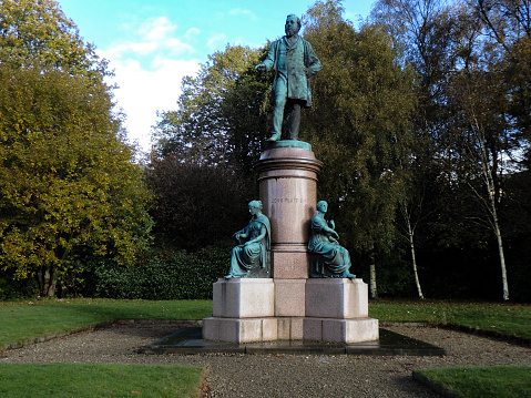 , United Kingdom – November 10, 2016: A statue of John Platt MP on a column supported by four female figures representing Engineering, Manufacturing, Science and Art.