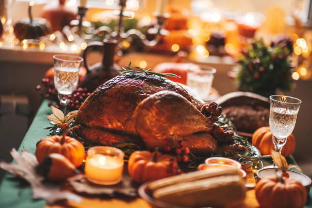 istock Thanksgiving holiday dinner table setting with fall decoration and pumpkins 1436957108