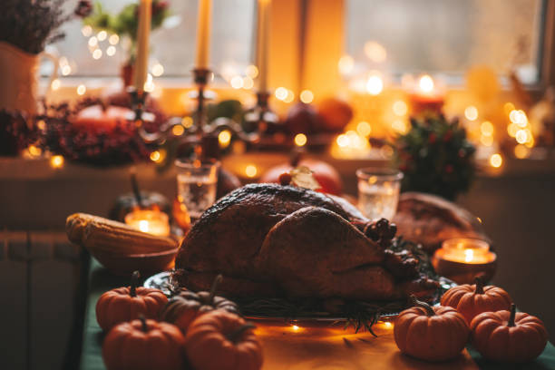 istock Thanksgiving holiday dinner table setting with fall decoration and pumpkins 1436957114