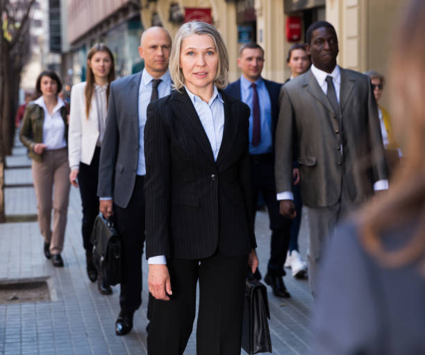 istock People in formal wear walking down street 1436957588
