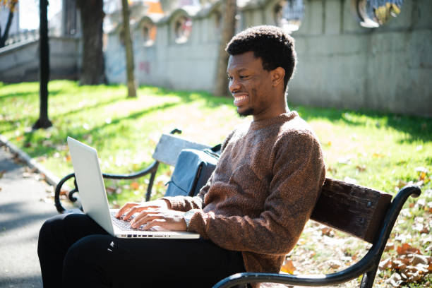 istock African American young man freelancing from the park 1436958518