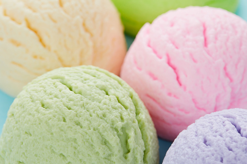 A selective focus shot of various flavored delicious ice cream scoops