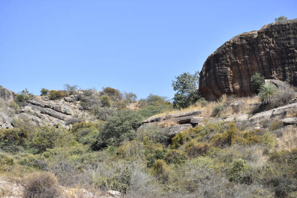 istock Huge rock formation in a desert landscape and a blue sky 1436960347