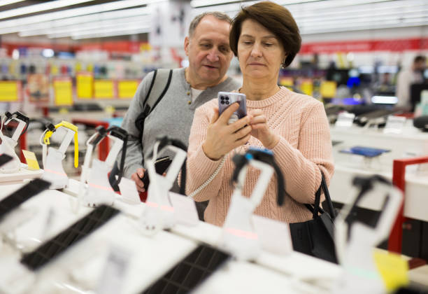 istock Senior couple choosing smartphone in tech store 1436960936