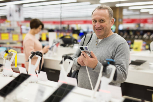 istock European man chooses a mobile phone 1436960937