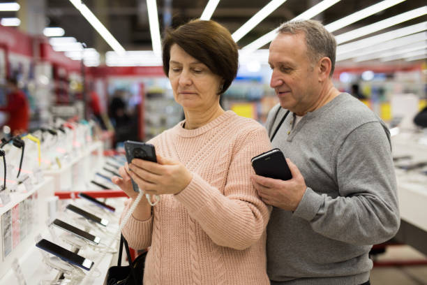 istock Senior couple choosing smartphone in tech store 1436960949