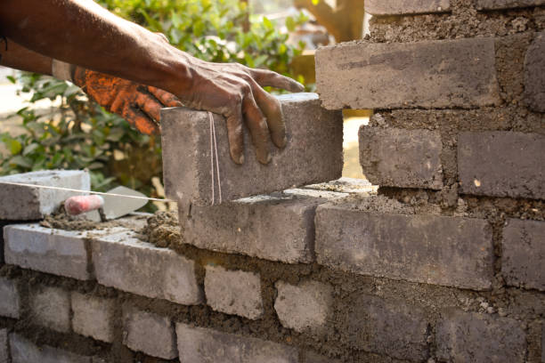istock Closeup of a man building a brick wall, outdoors during daylight 1436961046