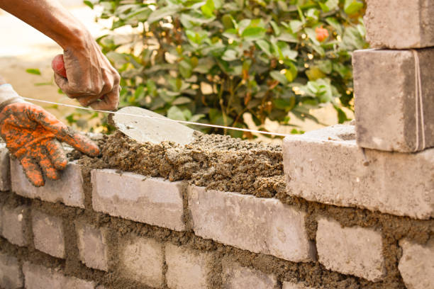 istock Closeup of a man building a brick wall, outdoors during daylight 1436961088