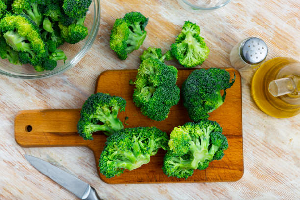istock Sliced fresh broccoli on  kitchen board with  knife. Cooking concept 1436961496