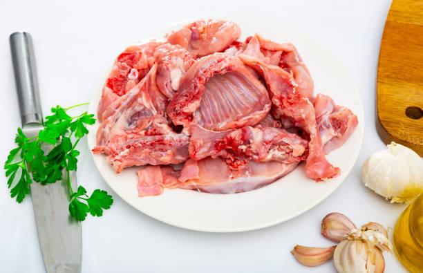 istock Rabbit sliced with herbs in white plate prepared for cooking 1436961540