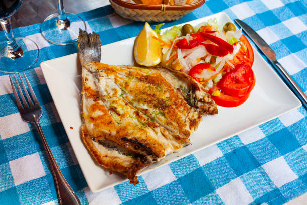 istock Fried dorada dressed with pesto served with vegetable garnish and lemon 1436961552