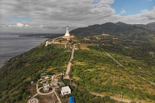 An aerial shot of the beautiful landscapes and famous Statue of Mother of All Asia, Philippines