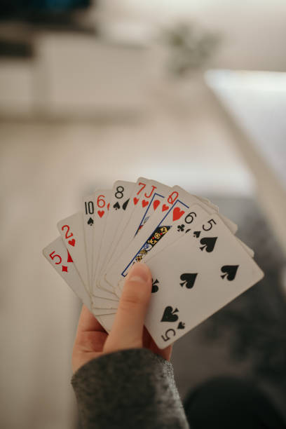 istock Closeup shot of hands holding playing cards 1436961843