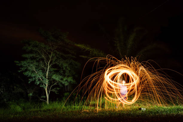istock Light painting with steel wool done by an unrecognizable person at night 1436962433