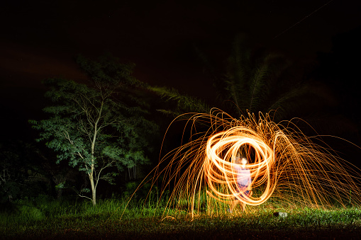 Perfect light painting with steel wool done by an unrecognizable person at night