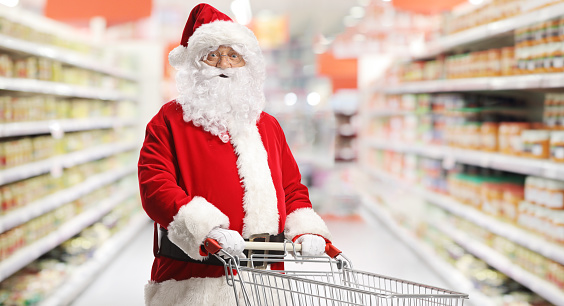 Santa claus with a shopping cart inside a supermarket