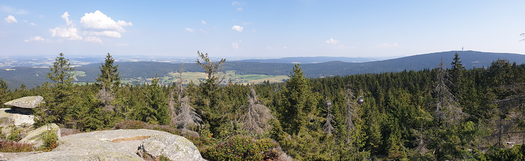 A scenic wide shot of the view from Ochsenkopf Mountain in Fichtelgebirge, Germany