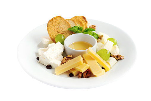 Cheese plate with honey, grapes and nuts for restaurant