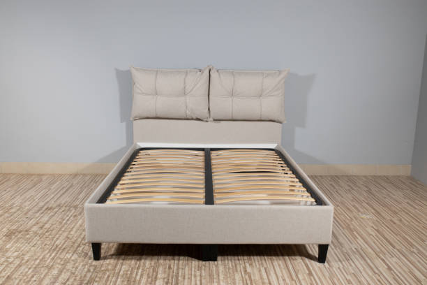 istock Bed with creme upholstery and wooden storage, without mattress 1436965059